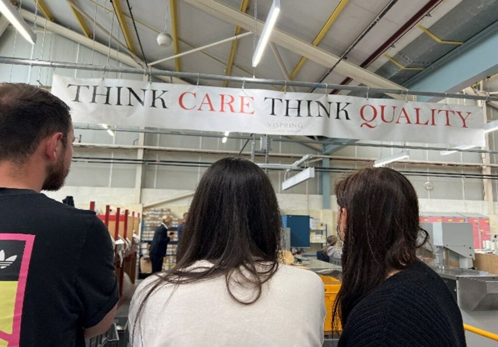 French Bedroom Colleagues at the Vispring Factory in Plymouth. Vispring motto, "Think Care Think Quality" banner overhead. 